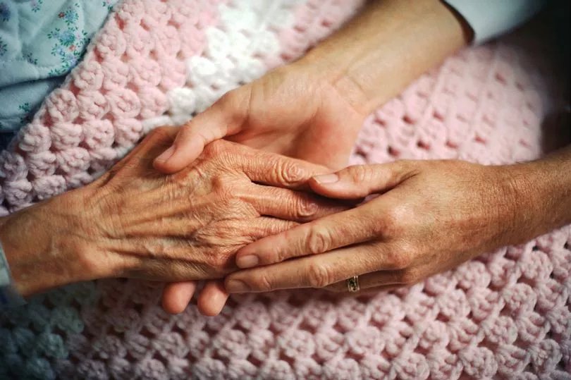 Holding hands on a crocheted quilt