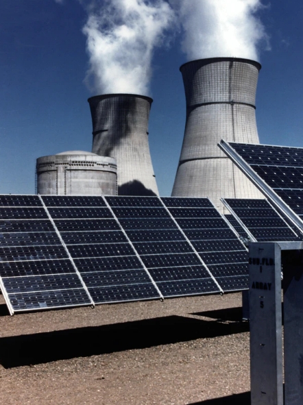 Accelerating Energy Transitions (Smokestacks behind rooftop solar panels)