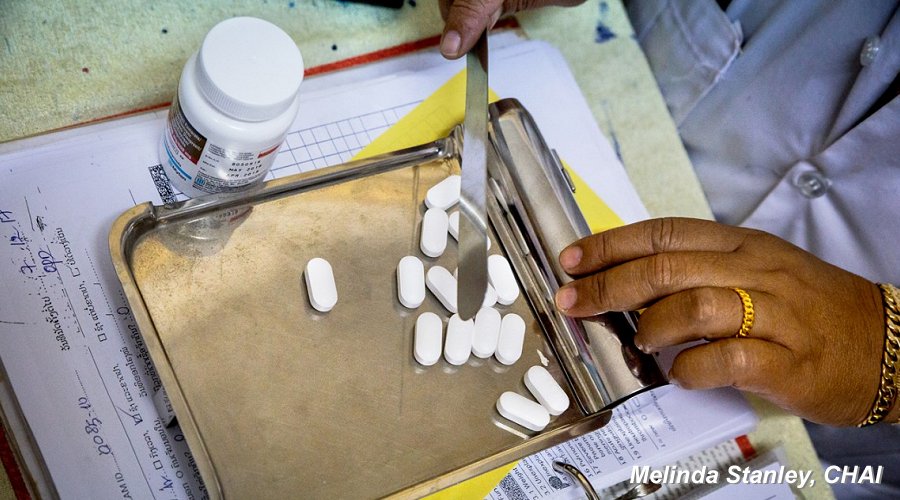 Pharmacy worker counts HIV treatment pills