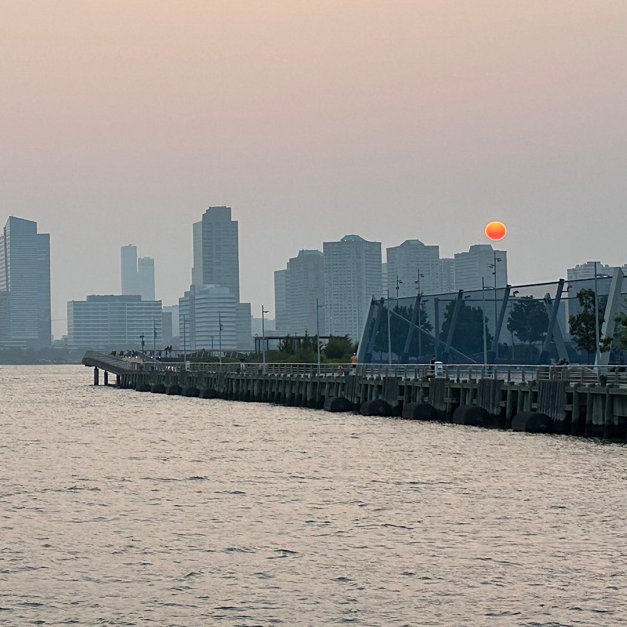 The setting sun over Hoboken, NJ across the Hudson River seen from Lower Manhattan during the wildfire smoke event this summer (Nathaniel Hupert/Provided)