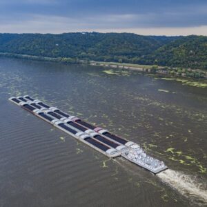 Algal blooms shown alongside barge floating down the Mississippi River