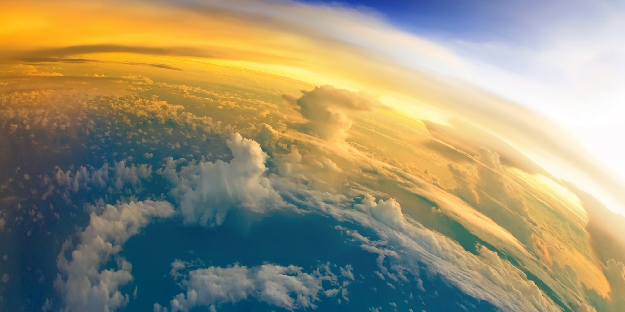 Aerial view of planet Earth with clouds and sunlight