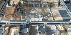 A construction 3D printer gantry is helping to build a Houston home that will be the first multistory 3D-printed structure in the U.S., also incorporating wood framing in a new hybrid design. (Lok/Zivkovic)