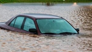 Car mostly submerged in flooded street