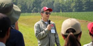 Louis Longchamps speaking with farmers